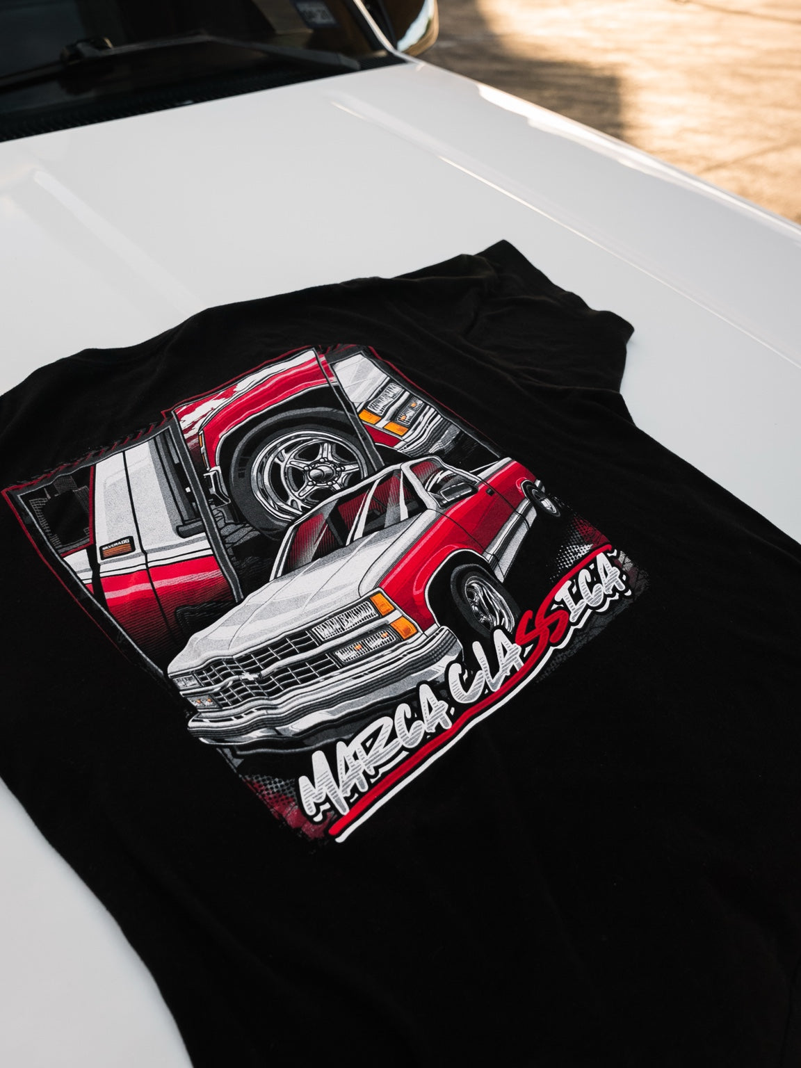 OBS shirt back design displayed on white truck hood